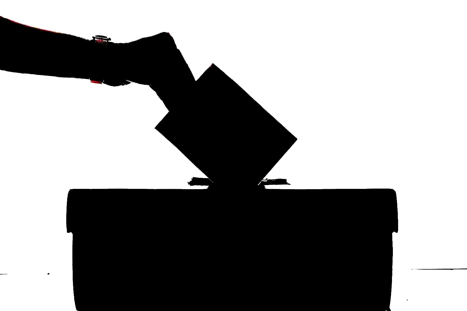 Hands marking a paper ballot, representing the act of corporate voting