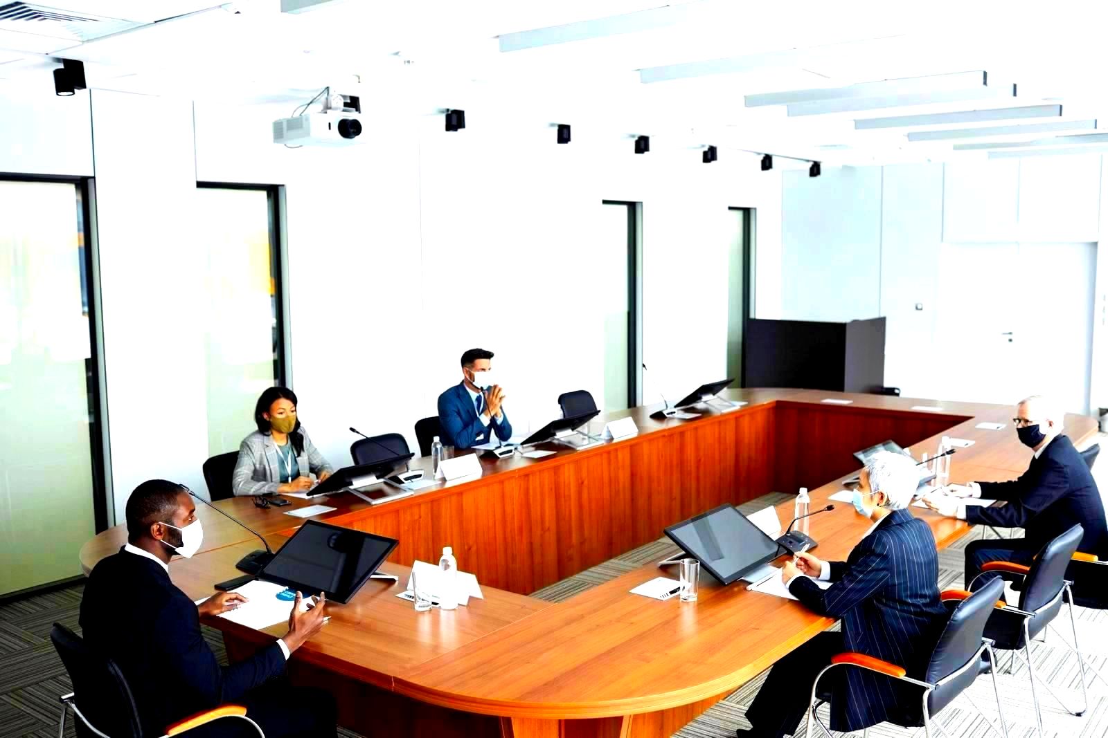 business professionals seated around a conference table in a meeting