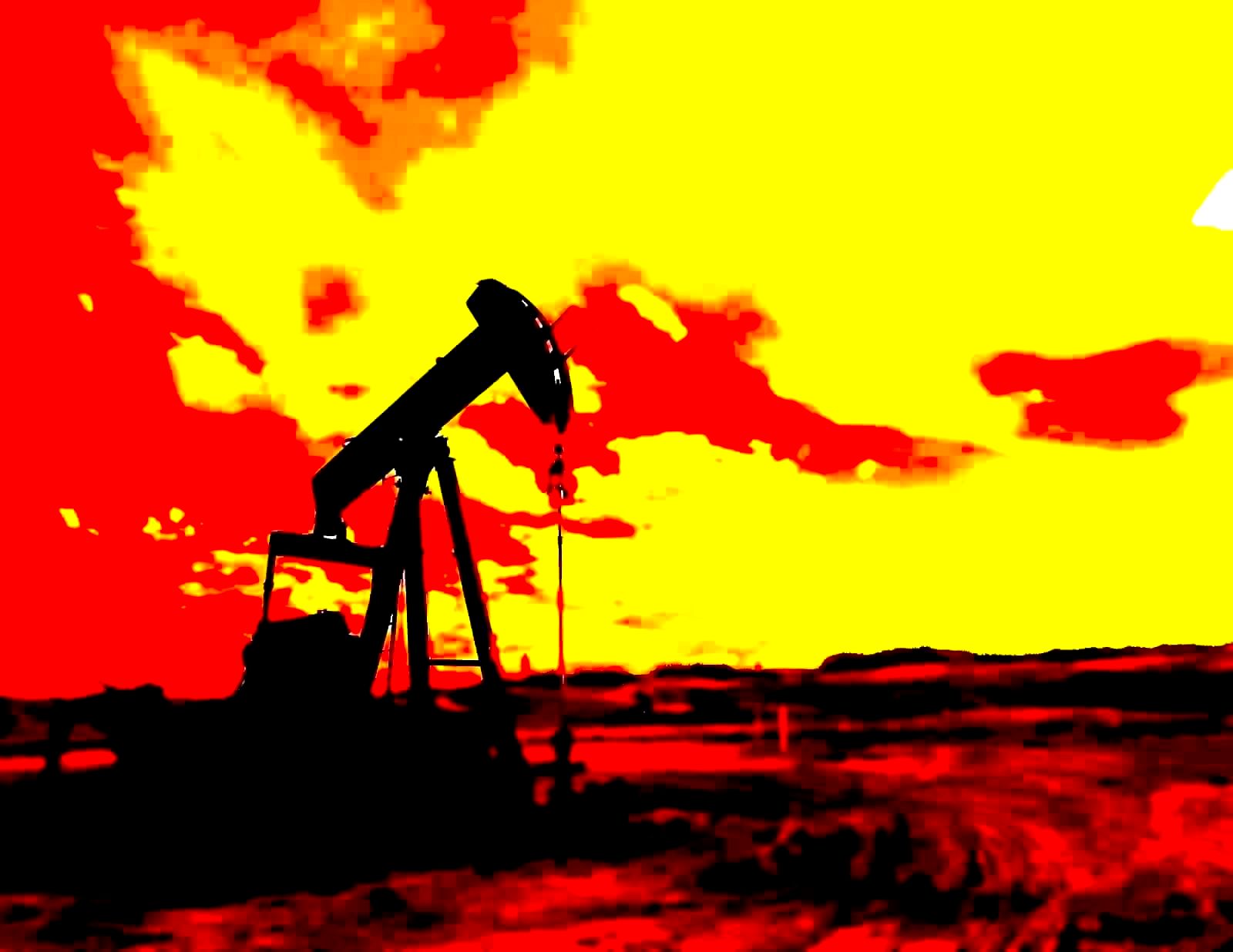 An oil pumpjack at sunset in a West Texas field