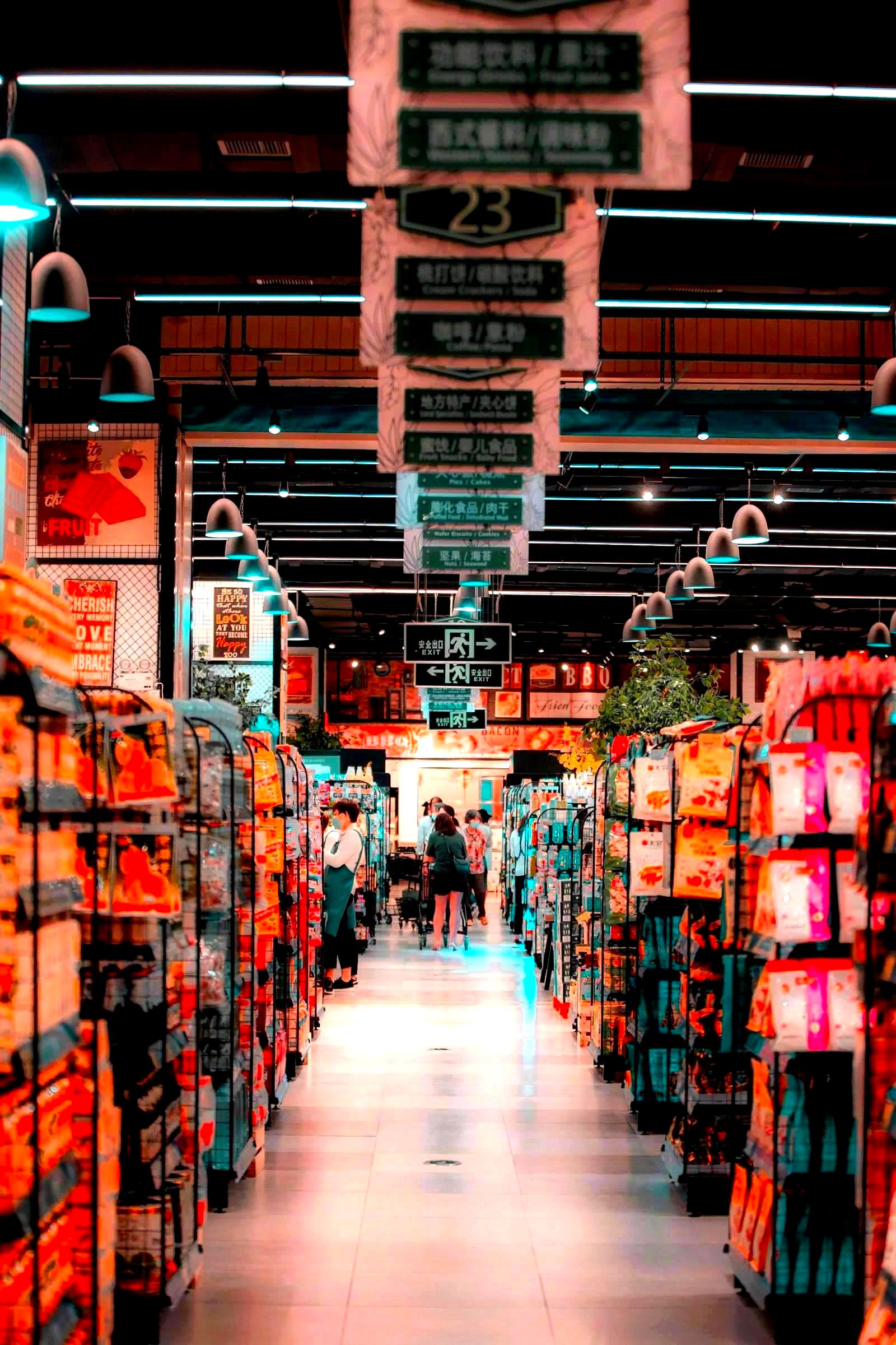 Shoppers browsing products in a large grocery store with full shelves